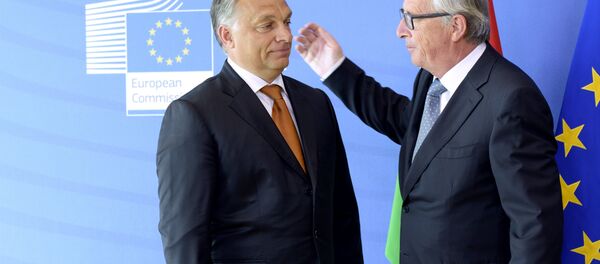 Hungary's Prime Minister Viktor Orban (L) is greeted by European Union Commission President Jean-Claude Juncker of Luxembourg prior to their meeting at the European Union Commission headquarter in Brussels. File photo - Sputnik International