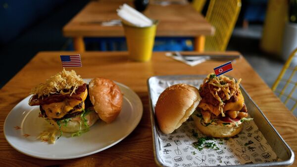 A Dirty Donald burger (L) and a Kim Jong Yum burger (R) is placed on a table at the Durty Bird restaurant in Hanoi on February 21, 2019 - Sputnik International