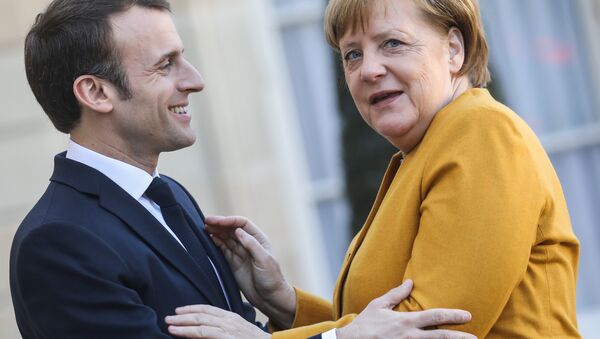 French President Emmanuel Macron (L) welcomes German Chancellor Angela Merkel as she arrives for a working meeting at the Elysee Palace on febuary 27, 2019, in Paris - Sputnik International