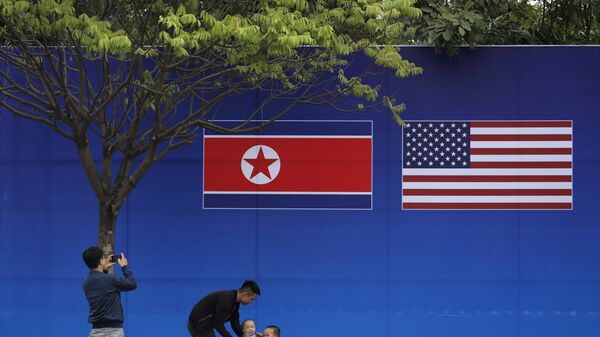 People take pictures in front of a poster featuring the upcoming second summit between the U.S. and North Korea in Hanoi, Vietnam - Sputnik International