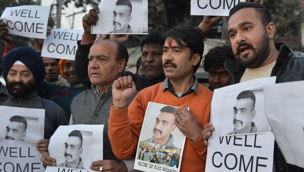 Indian people hold placards and photographs of Indian Air Force pilot Abhinandan Varthaman, as they celebrate the announcement of his soon release, in Amritsar on February 28, 2019. - Sputnik International