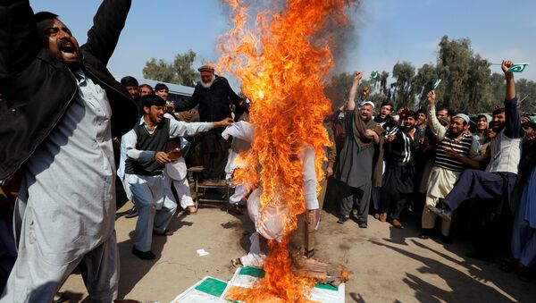 People chant slogans as they burn an effigy depicting Indian Prime Minister Narendra Modi, after Pakistan shot down two Indian military aircrafts, according to Pakistani officials, in Peshawar, Pakistan February 28, 2019 - Sputnik International