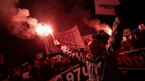 A demonstrator holds a flare during civic protest in Podgorica, Montenegro, March 2, 2019. - Sputnik International