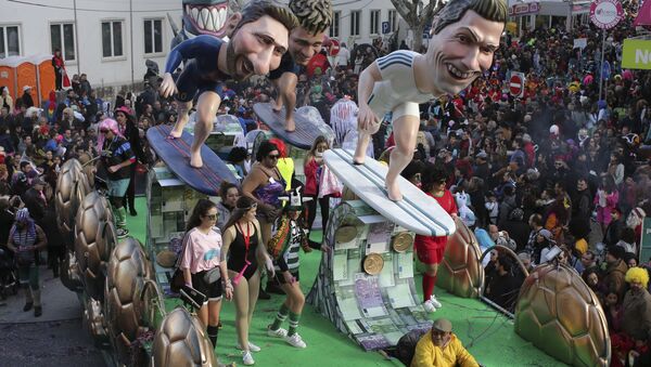 A float with sculptures of soccer players Lionel Messi, Neymar and Cristiano Ronaldo, from left to right, parades through the street during Carnival celebrations in Torres Vedras, north of Lisbon, Tuesday, Feb. 13 2018 - Sputnik International