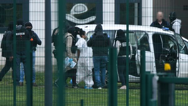 Michaël Chiolo, wearing a white forensic jumpsuit, is escorted into custody after the incident at Condon-sur-Sarthe prison - Sputnik International
