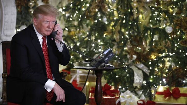 President Donald Trump listens on the phone as he shares updates to track Santa's movements from the North American Aerospace Defense Command (NORAD) Santa Tracker on Christmas Eve, 2018 - Sputnik International