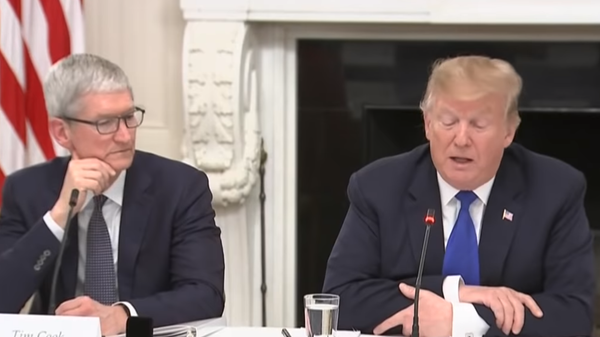US President Donald Trump and Apple CEO Tim Cook at a press conference in which Trump called Cook Tim Apple. Cook spoke at the White House on Wednesday about the various people they've been employing at the company and how half of their U.S. employees don't have four year degrees. - Sputnik International