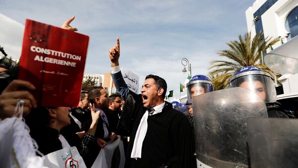 Lawyers chant slogans as they gesture near riot police outside the constitutional council during a protest denouncing an offer by President Abdelaziz Bouteflika to run in elections next month but not to serve a full term if re-elected, in Algiers, Algeria March 7, 2019. - Sputnik International