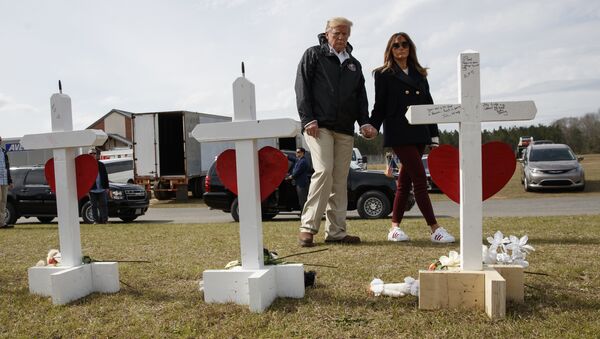 President Donald Trump and first lady Melania Trump visit a line of crosses at Providence Baptist Church in Smiths Station, Ala., Friday, March 8, 2019, as they tour areas where tornados killed 23 people in Lee County, Alabama - Sputnik International