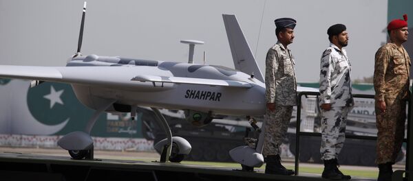 Pakistani soldiers stand beside a manufactured armed drone aircraft loaded on a vehicle is on display during a military parade in Islamabad, Pakistan, Friday, March 23, 2018. - Sputnik International