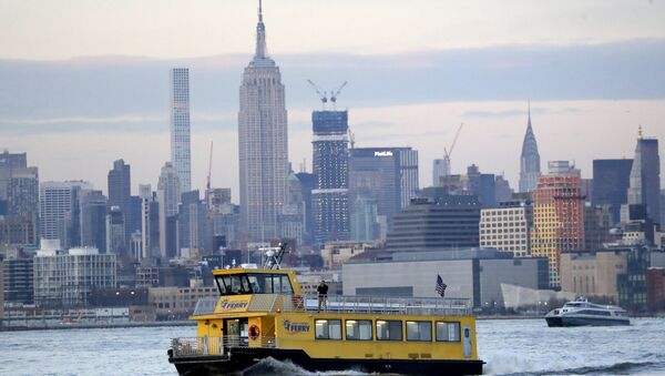 A liberty Landing Ferry boat chugs along the Hudson River with the Empire State Building seen at a distance, Thursday, Feb. 14, 2019 - Sputnik International