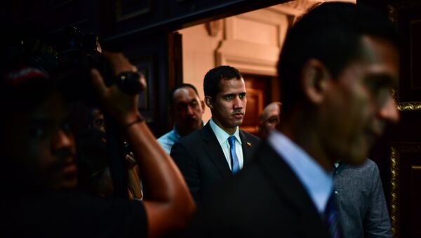 Venezuelan opposition leader and self-proclaimed acting president Juan Guaido (C) arrives at the Venezuelan National Assembly in Caracas on March 11, 2019. - Sputnik International