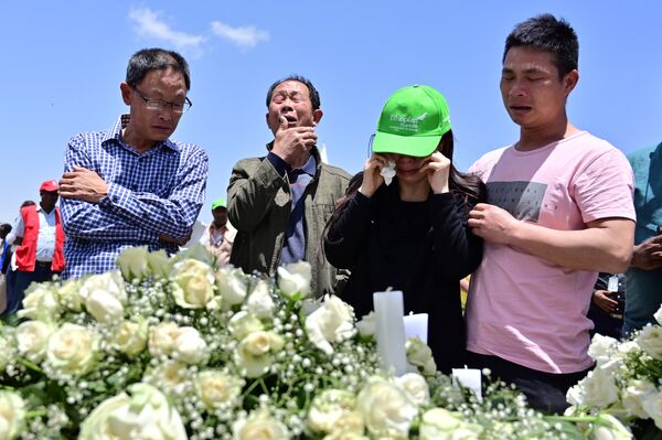 Family members mourn the victims at the crash site of the Ethiopian Airlines operated Boeing 737 MAX aircraft, at Hama Quntushele village in the Oromia region, on March 13, 2019 Family members mourn the victims at the crash site of the Ethiopian Airlines operated Boeing 737 MAX aircraft, at Hama Quntushele village in the Oromia region, on March 13, 2019 - Sputnik International