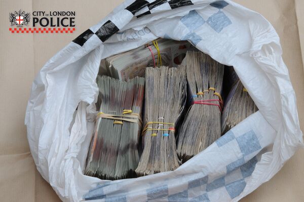 Almost £1 million in cash was discovered when City of London Police raided addresses in the capital in June 2018 Almost £1 million in cash was discovered when City of London Police raided addresses in the capital in June 2018 - Sputnik International