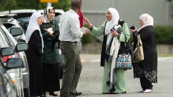 Members of a family react outside the mosque following a shooting at the Al Noor mosque in Christchurch - Sputnik International