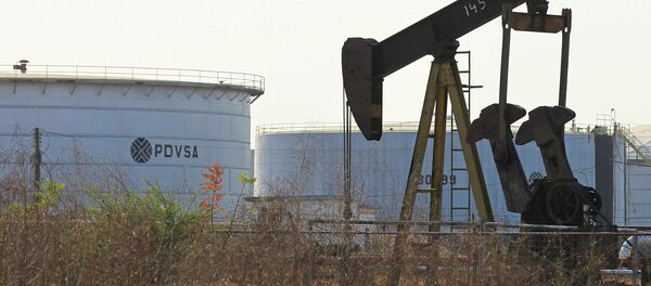 An oil pumpjack and a tank with the corporate logo of state oil company PDVSA are seen in an oil facility in Lagunillas An oil pumpjack and a tank with the corporate logo of state oil company PDVSA are seen in an oil facility in Lagunillas - Sputnik International