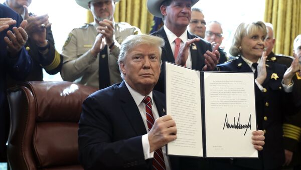 President Donald Trump speaks about border security in the Oval Office of the White House, Friday, March 15, 2019, in Washington. Trump issued the first veto of his presidency, overruling Congress to protect his emergency declaration for border wall funding. - Sputnik International