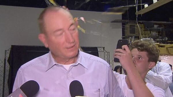 In this image made from video, a teenager breaks an egg on the head of Senator Fraser Anning while he holds a press conference, Saturday, March 16, 2019, in Melbourne - Sputnik International