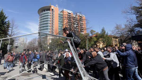 Supporters of the opposition party try to break through a police guarded fence near the office of Prime Minister Edi Rama during an anti-government protest in Tirana, Albania, March 16, 2019. - Sputnik International