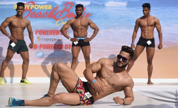 Indian male fitness models perform on stage during the 'Body Power Beach Show' - Sputnik International