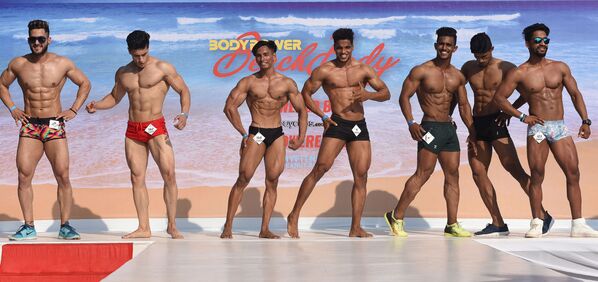 Indian male fitness models perform on stage during the 'Body Power Beach Show' - Sputnik International