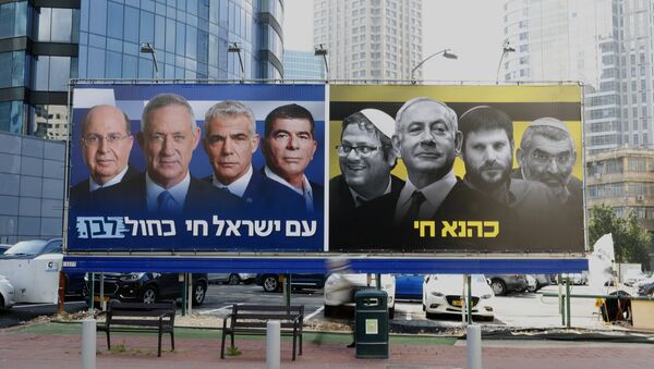 A picture taken on March 17, 2019 in the Israeli city of Ramat Gan in the suburbs of Tel Aviv shows a billboard bearing portraits of Blue and White (Kahol Lavan) political alliance leaders Moshe Yaalon, Benny Gantz, Yair Lapid and Gabi Ashkenazi, with a caption below reading in Hebrew The nation of Israeli lives; alongside another billboard showing Prime Minister Benjamin Netanyahu flanked by extreme right politicians Itamar Ben Gvir, Bezalel Smotrich and Michael Ben Ari, with another caption in Hebrew reading Kahana Lives in a reference to a banned ultranationalist party in the 1994. - Sputnik International