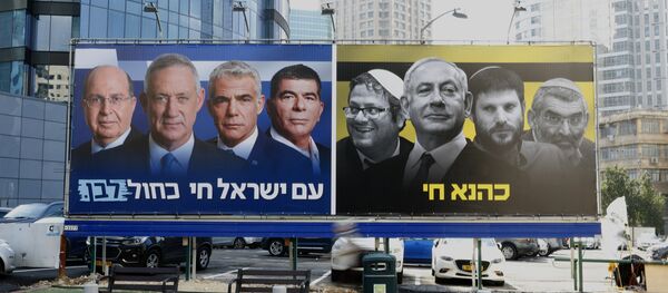 A picture taken on March 17, 2019 in the Israeli city of Ramat Gan in the suburbs of Tel Aviv shows a billboard bearing portraits of Blue and White (Kahol Lavan) political alliance leaders Moshe Yaalon, Benny Gantz, Yair Lapid and Gabi Ashkenazi, with a caption below reading in Hebrew The nation of Israeli lives; alongside another billboard showing Prime Minister Benjamin Netanyahu flanked by extreme right politicians Itamar Ben Gvir, Bezalel Smotrich and Michael Ben Ari, with another caption in Hebrew reading Kahana Lives in a reference to a banned ultranationalist party in the 1994. A picture taken on March 17, 2019 in the Israeli city of Ramat Gan in the suburbs of Tel Aviv shows a billboard bearing portraits of Blue and White (Kahol Lavan) political alliance leaders Moshe Yaalon, Benny Gantz, Yair Lapid and Gabi Ashkenazi, with a caption below reading in Hebrew The nation of Israeli lives; alongside another billboard showing Prime Minister Benjamin Netanyahu flanked by extreme right politicians Itamar Ben Gvir, Bezalel Smotrich and Michael Ben Ari, with another caption in Hebrew reading Kahana Lives in a reference to a banned ultranationalist party in the 1994. - Sputnik International