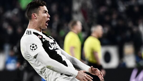 Juventus' Portuguese forward Cristiano Ronaldo celebrates after scoring 3-0 during the UEFA Champions League round of 16 second-leg football match Juventus vs Atletico Madrid on March 12, 2019 at the Juventus stadium in Turin. - Sputnik International