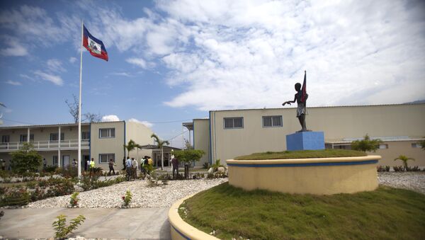 In this March 15, 2013 photo, Haiti's national flag flies outside parliament which was renovated by Chemonics International Inc., a for-profit international development company based in Washington D.C., in downtown of Port-au-Prince, Haiti. - Sputnik International