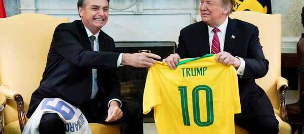 Brazil's President Jair Bolsonaro presents a Brazil naitonal soccer team jersey to US President Donald Trump after Trump gave him a US soccer team jersey during a meeting in the Oval Office of the White House in Washington, US, March 19, 2019. Brazil's President Jair Bolsonaro presents a Brazil naitonal soccer team jersey to US President Donald Trump after Trump gave him a US soccer team jersey during a meeting in the Oval Office of the White House in Washington, US, March 19, 2019. - Sputnik International
