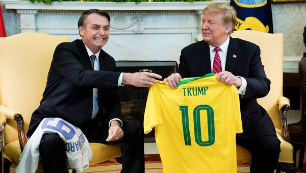 Brazil's President Jair Bolsonaro presents a Brazil naitonal soccer team jersey to US President Donald Trump after Trump gave him a US soccer team jersey during a meeting in the Oval Office of the White House in Washington, US, March 19, 2019. - Sputnik International