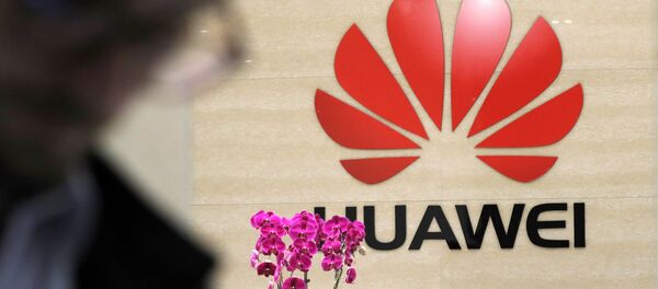 A logo of Huawei hangs in the lobby of the Cyber Security Lab at Huawei factory in Dongguan, China's Guangdong province - Sputnik International