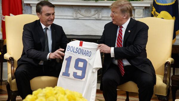 President Donald Trump presents Brazilian President Jair Bolsonaro with a U.S. national team soccer jersey during a meeting in the Oval Office of the White House, Tuesday, March 19, 2019, in Washington. (AP Photo/Evan Vucci) - Sputnik International