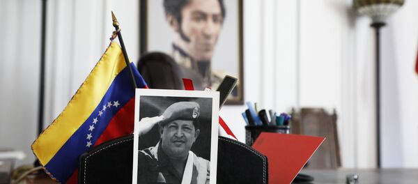 A photograph of Venezuela's late President Hugo Chavez and a painting of Venezuelan independence hero Simon Bolivar sit in an office at the Venezuelan consulate, two days after it was taken over by supporters of self-declared interim president of Venezuela, Juan Guaido, in New York, Wednesday, March 20, 2019. In Caracas, the Venezuelan government of President Nicolas Maduro denounced the forced and illegal occupation of some of its diplomatic headquarters in the United States. A photograph of Venezuela's late President Hugo Chavez and a painting of Venezuelan independence hero Simon Bolivar sit in an office at the Venezuelan consulate, two days after it was taken over by supporters of self-declared interim president of Venezuela, Juan Guaido, in New York, Wednesday, March 20, 2019. In Caracas, the Venezuelan government of President Nicolas Maduro denounced the forced and illegal occupation of some of its diplomatic headquarters in the United States. - Sputnik International