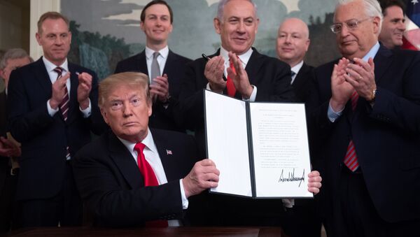 U.S. President Donald Trump holds a proclamation recognizing Israel's sovereignty over the Golan Heights as he is applauded by Israel's Prime Minister Benjamin Netanyahu and others during a ceremony in the Diplomatic Reception Room at the White House in Washington, U.S., March 25, 2019 - Sputnik International