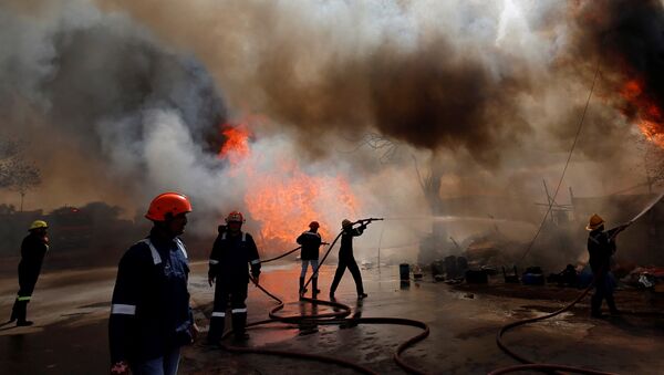 Firefighters attempt to douse a fire that broke out at a wood store in Ahmedabad, India, March 24, 2019 - Sputnik International