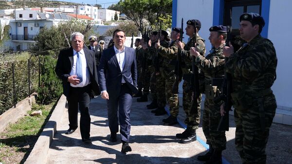 Greek Prime Minister Alexis Tsipras and Mayor of Agathonisi Evangelos Kottoros review a guard of honour during a visit on the island of Agathonisi, Greece March 25, 2019. - Sputnik International