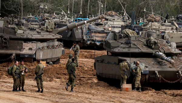 Israeli soldiers stand next to tanks and armoured personnel carriers (APC) near the border with Gaza, in southern Israel March 26, 2019. - Sputnik International