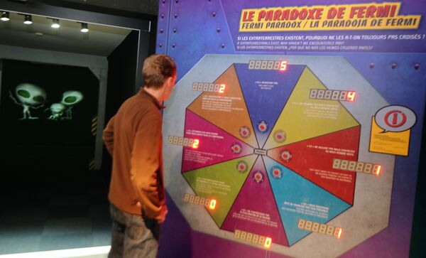 A person stands by a presentation on the paradox of Fermi, the Italian physicist, on April 1, 2010 at a new scientific exhibition on extraterrestrial activity at the 'Cite de l'espace' in Toulouse, south west France A person stands by a presentation on the paradox of Fermi, the Italian physicist, on April 1, 2010 at a new scientific exhibition on extraterrestrial activity at the 'Cite de l'espace' in Toulouse, south west France - Sputnik International