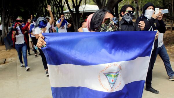 Masked demonstrators take part in a protest against Nicaraguan President Daniel Ortega's government - Sputnik International