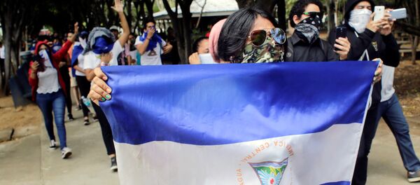 Masked demonstrators take part in a protest against Nicaraguan President Daniel Ortega's government Masked demonstrators take part in a protest against Nicaraguan President Daniel Ortega's government - Sputnik International