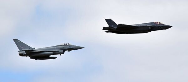 A British Royal Air Force (RAF) Lockheed Martin F-35 Lightning II (R) and a Eurofighter Typhoon aircraft perform a fly-past during the Farnborough Airshow, south west of London, on July 17, 2018 A British Royal Air Force (RAF) Lockheed Martin F-35 Lightning II (R) and a Eurofighter Typhoon aircraft perform a fly-past during the Farnborough Airshow, south west of London, on July 17, 2018 - Sputnik International