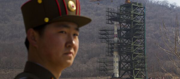 A North Korean soldier stands in front of the country's Unha-3 rocket, slated for liftoff between April 12-16, at a launching site in Tongchang-ri, North Korea on Sunday April 8, 2012. A North Korean soldier stands in front of the country's Unha-3 rocket, slated for liftoff between April 12-16, at a launching site in Tongchang-ri, North Korea on Sunday April 8, 2012. - Sputnik International