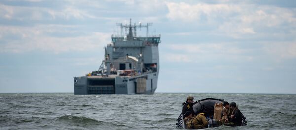 Sailors assigned to Explosive Ordnance Disposal Mobile Unit (EODMU) 2 man a combat rubber raiding craft while underway with the Royal Fleet Auxiliary landing ship dock Mounts Bay during a mine countermeasures (MCM) task group experiment. - Sputnik International