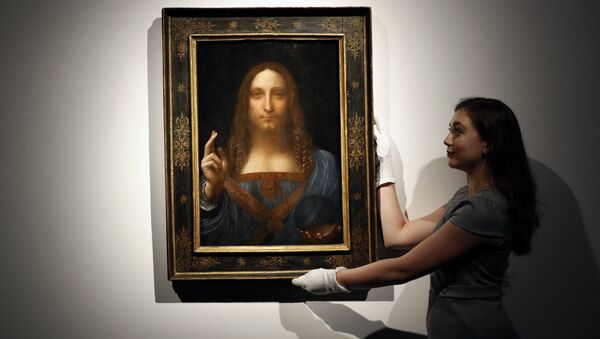 In this Oct. 24, 2017 file photo, an employee poses with Leonardo da Vinci's Salvator Mundi on display at Christie's auction rooms in London.  - Sputnik International