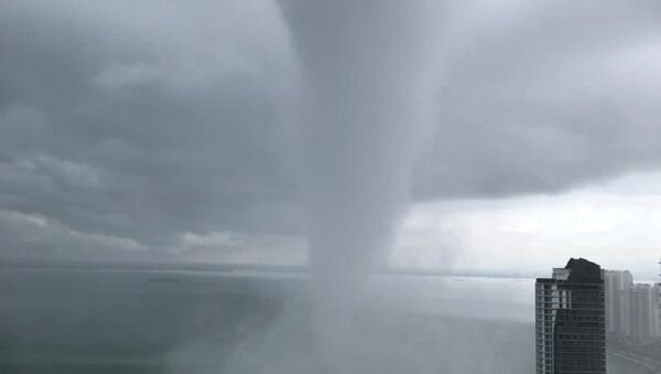 A waterspout is seen on the shores of Penang, Malaysia, April 1, 2019, in this image obtained from social media on April 1, 2019 - Sputnik International