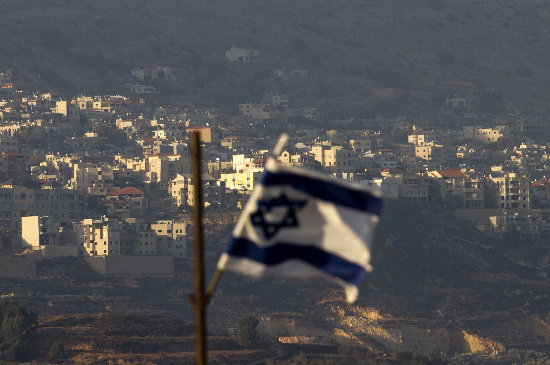 Oct. 11, 2018, an Israeli flag in front of the village of Majdal Shams in the Israeli-controlled Golan Heights. Syria slammed President Donald Trump's abrupt declaration that Washington will recognise Israel's sovereignty over the Israeli-occupied Golan Heights, saying Friday March 22, 2019, the statement was irresponsible and a threat to international peace and stability - Sputnik International, 1920, 11.10.2021