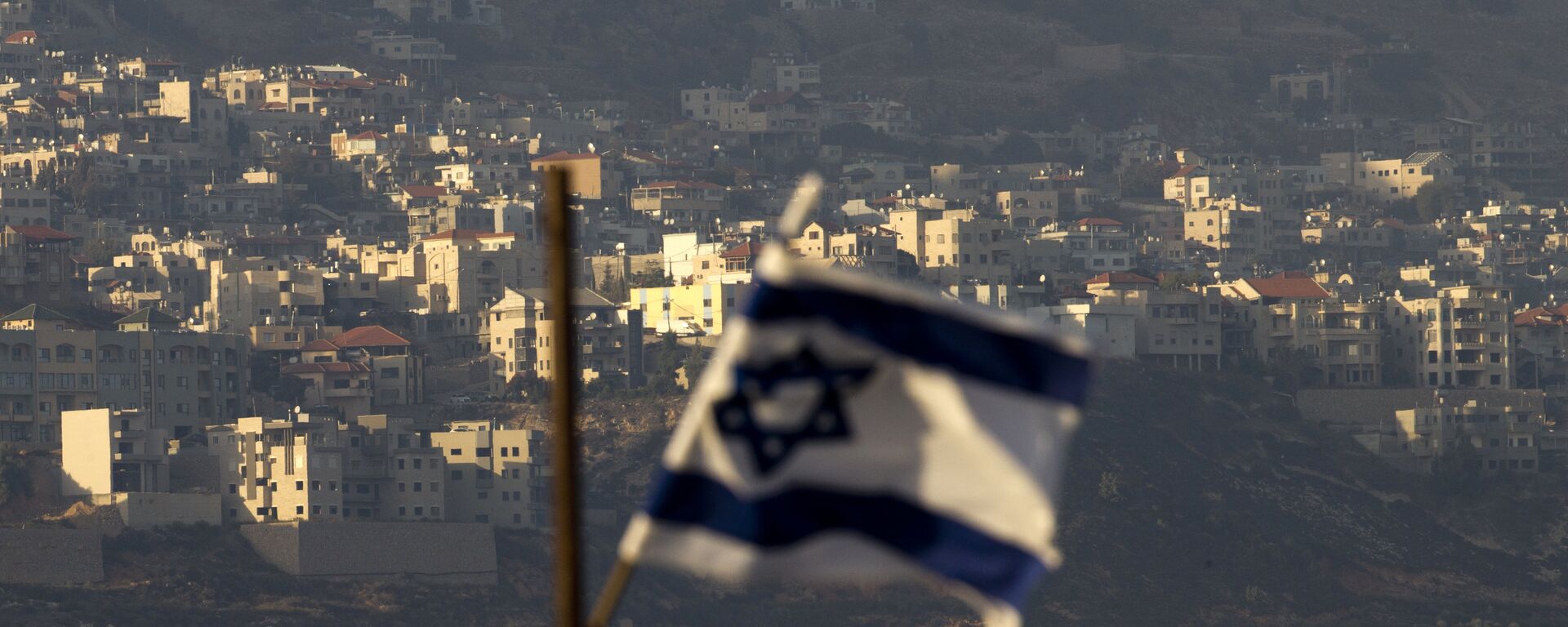Oct. 11, 2018, an Israeli flag in front of the village of Majdal Shams in the Israeli-controlled Golan Heights. Syria slammed President Donald Trump's abrupt declaration that Washington will recognise Israel's sovereignty over the Israeli-occupied Golan Heights, saying Friday March 22, 2019, the statement was irresponsible and a threat to international peace and stability - Sputnik International, 1920, 07.02.2021