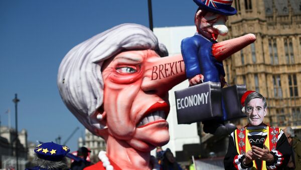 A man wearing a mask of Britain's Conservative Party MP Jacob Rees-Mogg is pictured next to anti-Brexit protesters outside the Houses of Parliament in London, Britain April 1, 2019 - Sputnik International