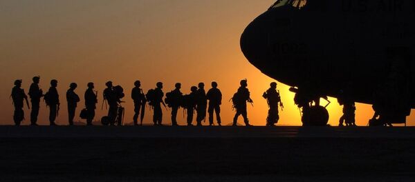 The sun sets behind a C-17 Globemasterat Joint Base Balad, Iraq, as Soldiers begin boarding - Sputnik International